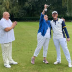 Finals Weekend 2024 - Runnerup lifts her trophy aloft in celebration while the club captain and winner look on smiling